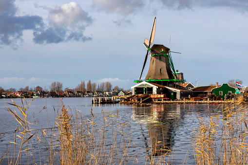 Zaanse schans, Netherlands - December 17, 2017: windmills at Zaanse Schans, an industrial and national Dutch heritage site and famous tourist destination in the municipality of Zaandam, the Netherlands. Zaanse Schans is located on the river Zaan, from which its name derives.