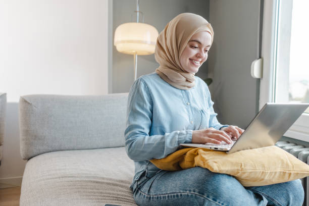 istock Young Middle-Eastern woman using a laptop at home 1457751214