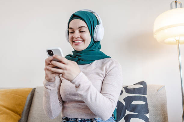istock Smiling young woman consuming online content 1457751310