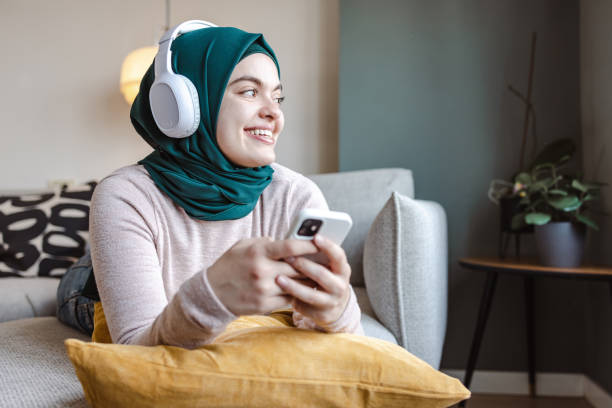 istock Young woman relaxing and using smart phone 1457751330