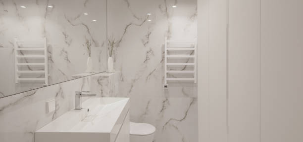 istock Modern minimalist white bathroom interior design with marble style tiles and white taps, vase and wall heater 1457751361