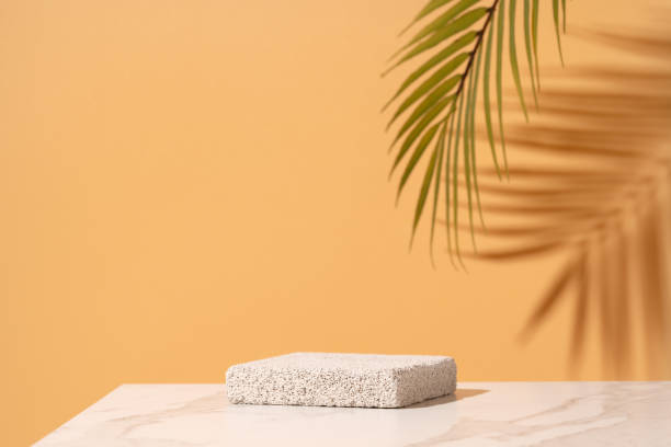 istock Empty podium for cosmetics beauty product presentation. Made with pumice stone on a bathroom table on yellow. 1457751423