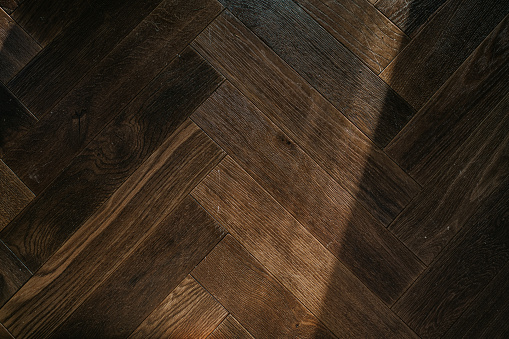 Background image of a tiled floored in a parquet flooring style.