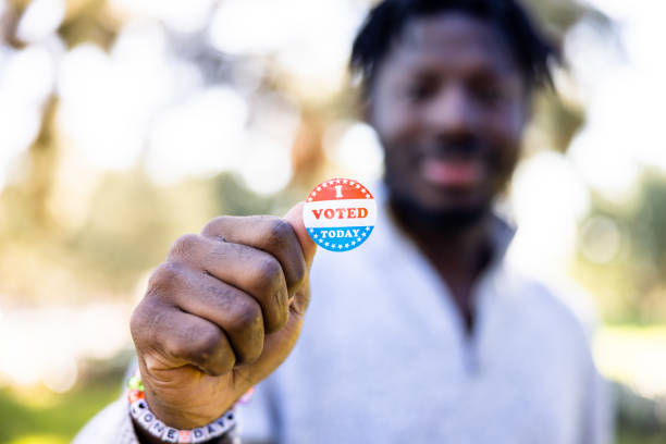 istock Young black man with an I voted sticker for an election 1457751568