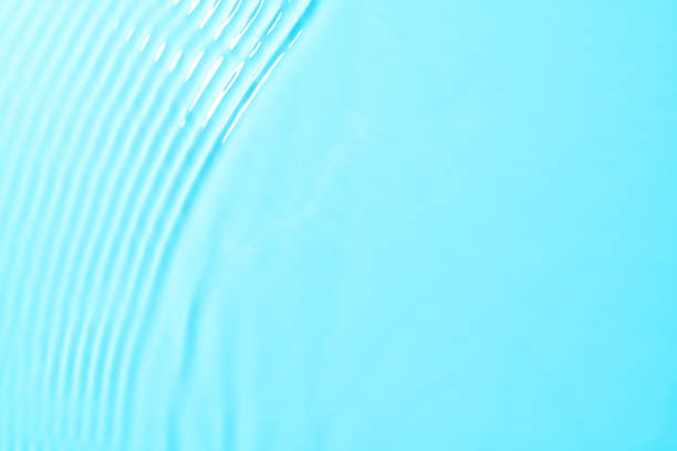 istock Delicate blue water texture mockup background with light reflection. Water surface mock up. 1457752830