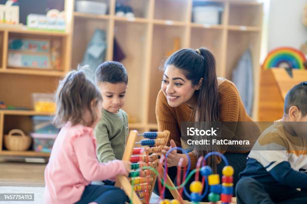 Learning Through Play Stock Photo - Download Image Now - Teacher, Child, Classroom