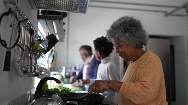 Family cooking and talking in the kitchen at home