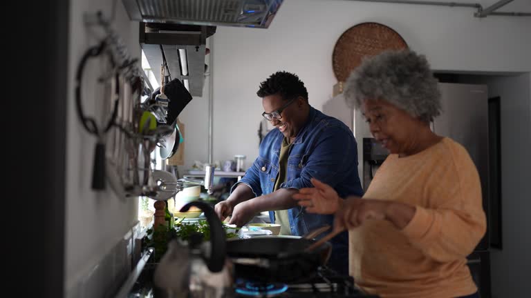 Mother and son cooking in the kitchen at home