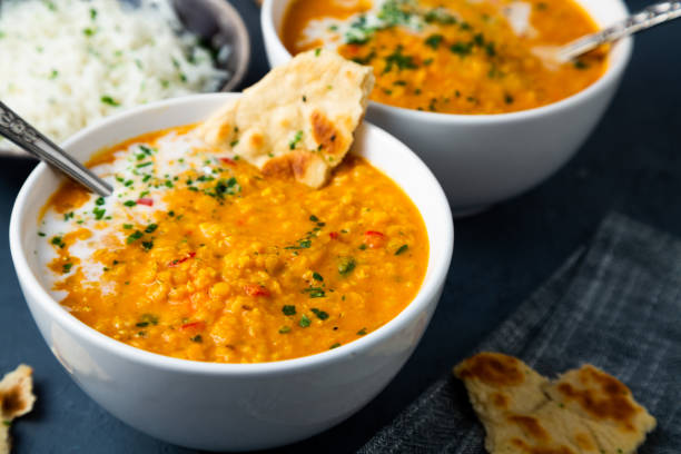 istock Spicy red lentil soup with naan bread and basmati rice 1457757177