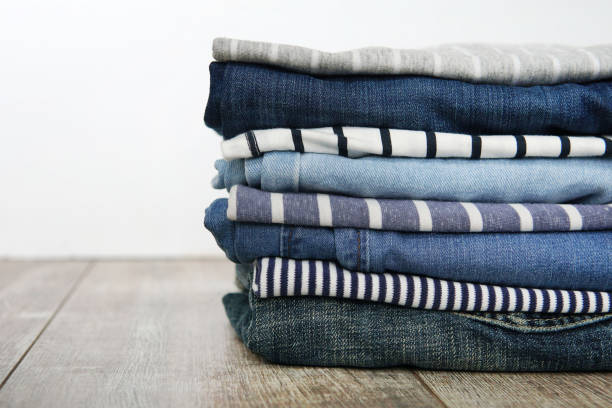 istock Stack of folded clothes jeans and striped T-shirts 1457759757