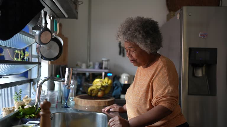 Worried senior woman in the kitchen at home