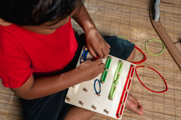 istock an asian little boy playing geometric nail plate, a creative game for early development and good motor skills 1457762412