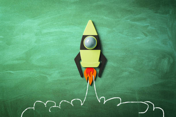 istock Startup and business concept with taking off bright graphic rocket on green chalkboard background. 3D rendering 1457762528