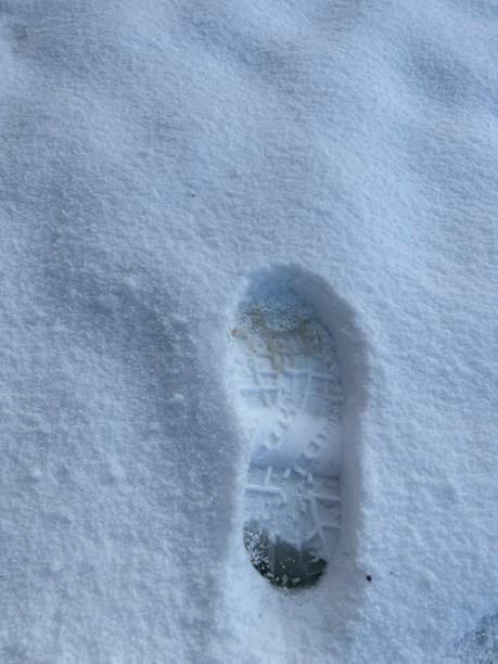 istock human foot print on the white layer of snow 1457763076