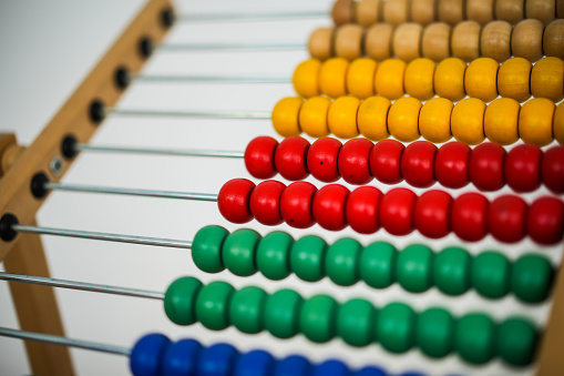 Close up shot of a wooden multi colored abacus.