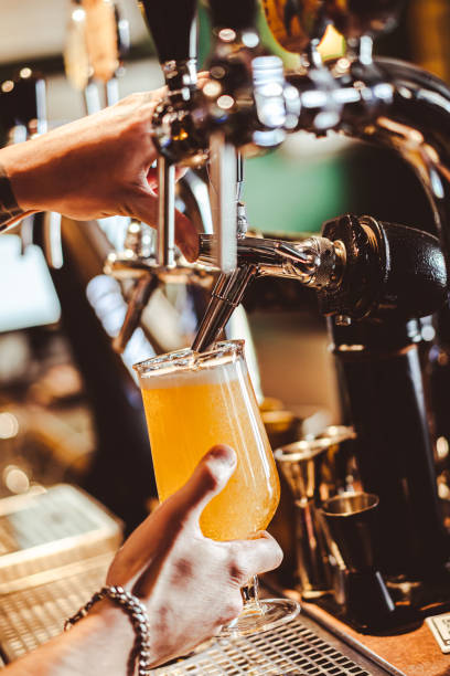 istock Bartender filling beer from tap at bar 1457763746