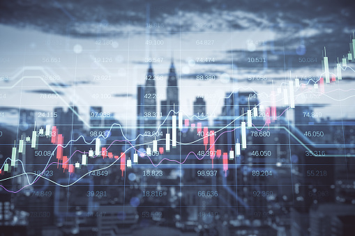 Investing and trading concept with digital rising up financial chart candlestick and diagrams on blurred city skyline background, double exposure