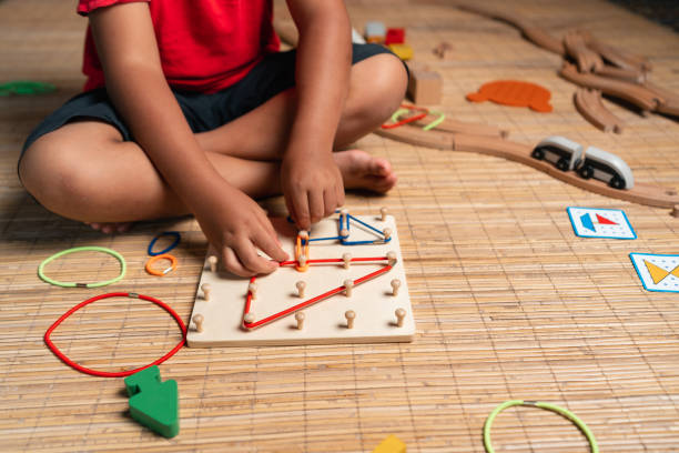 istock an asian little boy playing geometric nail plate, a creative game for early development and good motor skills 1457765806