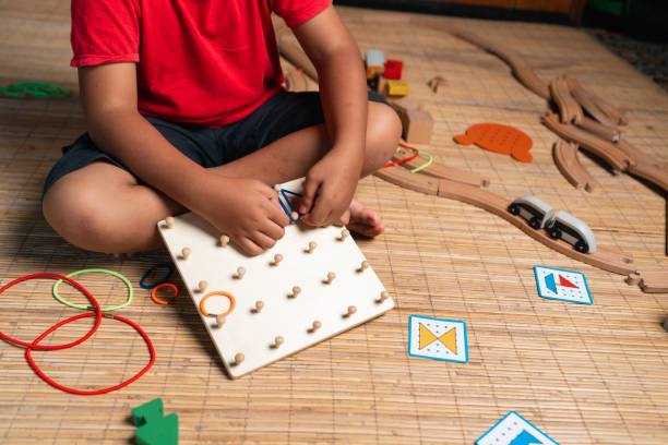 istock an asian little boy playing geometric nail plate, a creative game for early development and good motor skills 1457765807
