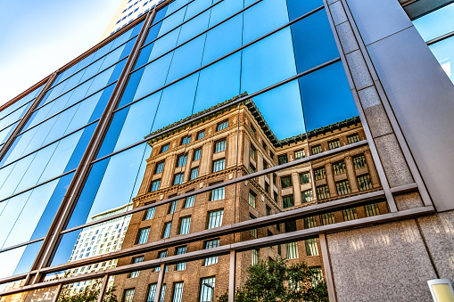 Clouds reflected in windows of modern office building