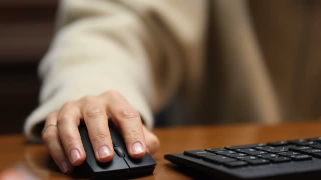 Woman with wrist pain from using computer mouse