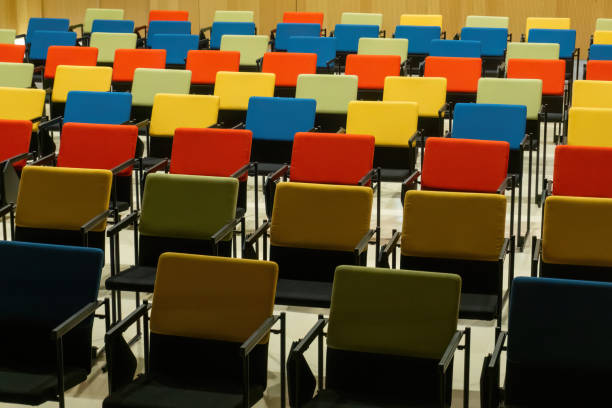istock Straight rows of colourful chairs in the hall 1457771485