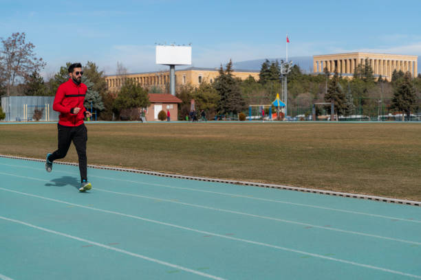 young man doing sports on the running track