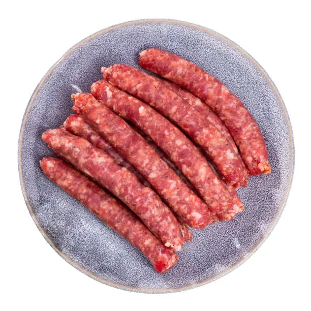 Photo of Raw longaniza from minced pork on plate. Popular Catalan sort of sausages