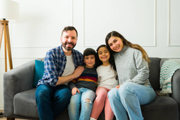 istock Loving relaxed family sitting on the sofa smiling 1457775339