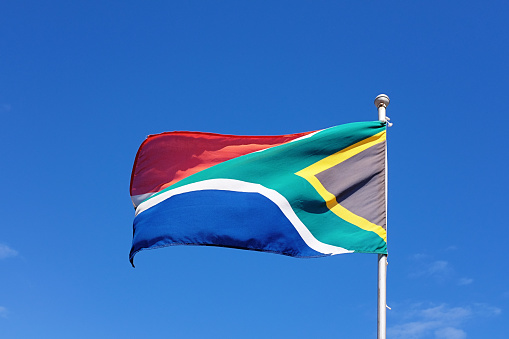 Close-up view of the Guyana national flag waving in the wind. The Co‑operative Republic of Guyana is a country on the northern mainland of South America. Fabric textured background. Selective focus