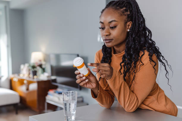 istock Worried young woman reading medicine instructions 1457776614