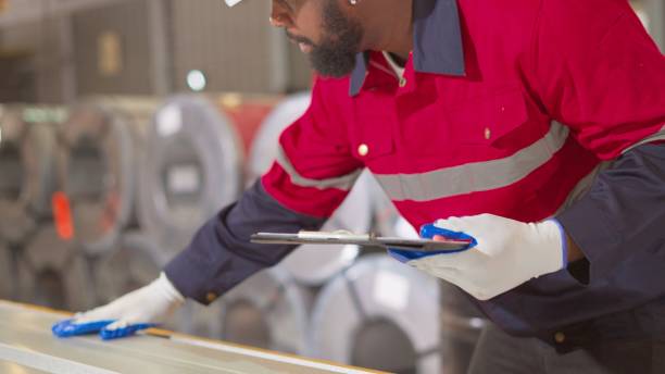 istock Professional African American industrial engineer or technician wear personal protective equipment, monitor production line process of assembly part, inspect specification of products that come out of machines in the production process in manufacturing. 1457777958