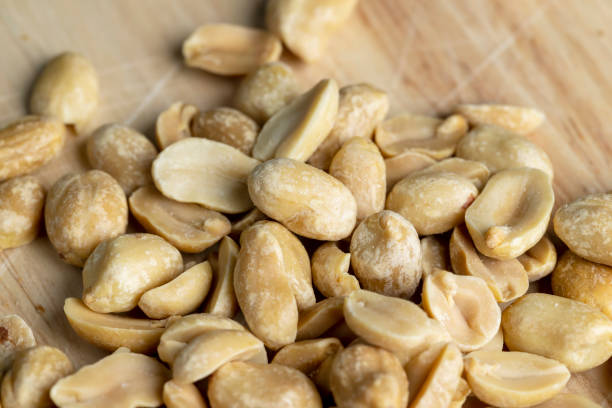 istock Roasted peanuts on a wooden cutting board 1457780493