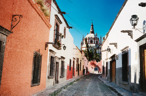 Looking along  Aladama street and it's cobblestones, with the  back of the world famous Parroquia cathedral in the distance - in the town of San Miguel de Allende.