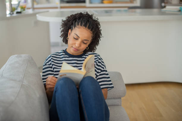istock Woman relaxing and reading a book 1457784641