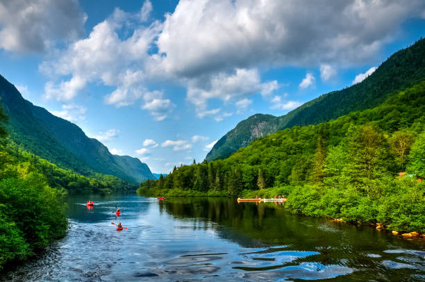 Adventurous people rafting Jacques Cartier river