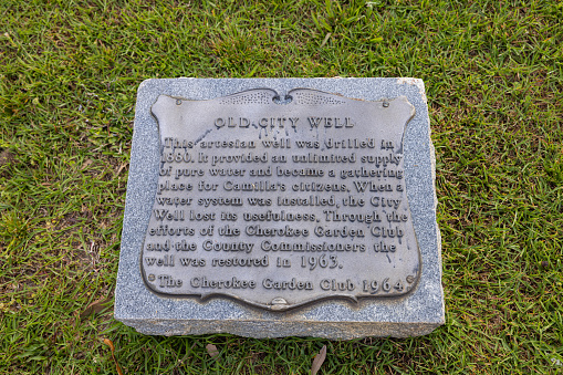 Camilla, Georgia, USA - April 17, 2022: Plaque tells the history and marks the place of the Old City Well