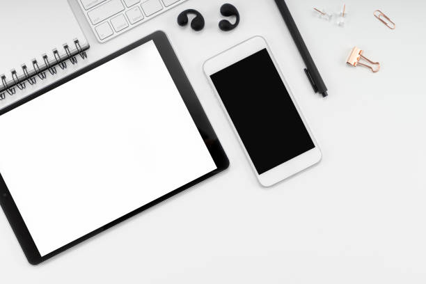 Modern white workspace top view, smartphone and tablet blank screen mockup. stock photo