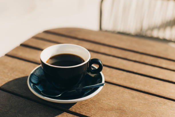 istock Cup of black coffee on a table in a street cafe. Selective focus. 1457795767