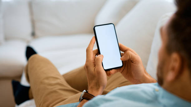 istock Close up of man using smart phone at home. 1457798998