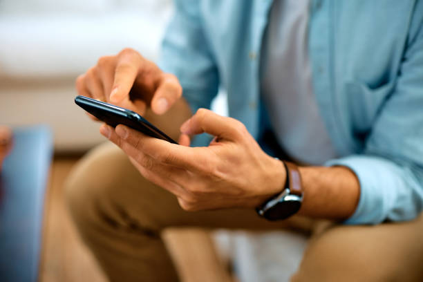 istock Close up of man using mobile phone. 1457799328