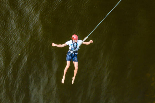 Kiev, Ukraine - July 28, 2018: Young man bungee jumper jumping from bridge