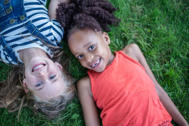 istock Children Laying in the Grass 1457806647