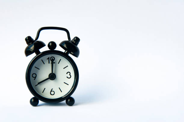 istock Alarm clock pointing at 8 am or pm with customizable space for text or ideas. Copy space. 1457806649