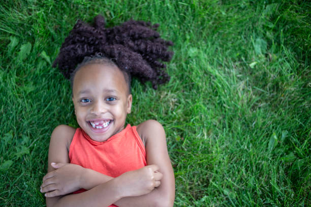 istock Children Laying in the Grass 1457807187