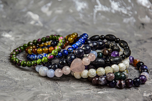 A collection of colorful bracelets created with various natural, round gemstone beads