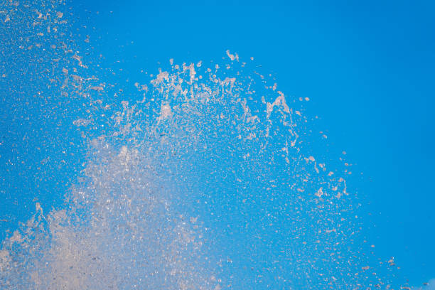 istock Splashes of water against the blue sky background 1457807625