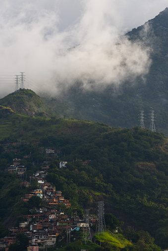The cloud-shrouded Atlantic rainforest of the Tijuca National Park above a favela, Zona Norte, or North Zone, Rio de Janeiro, Brazil