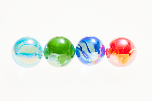 Six colorful balls of modeling clay on a white background. Spheres of plasticine. Joyful mood. Bright colors.
