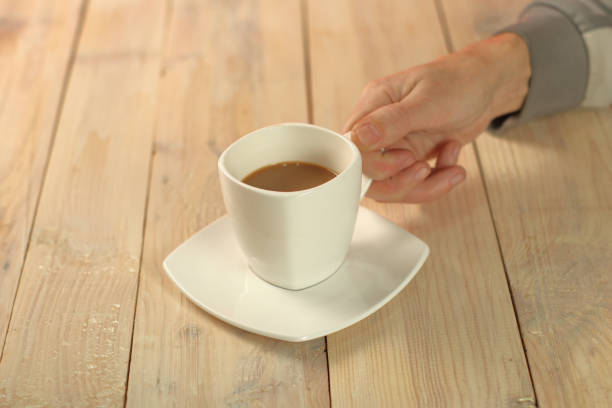 istock person holding a cup with coffee 1457812905